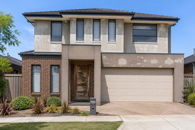 "Double-storey brick veneer home in Grand Lakes Lara before exterior repaint — UV-faded render and chalking paint on upper storey"